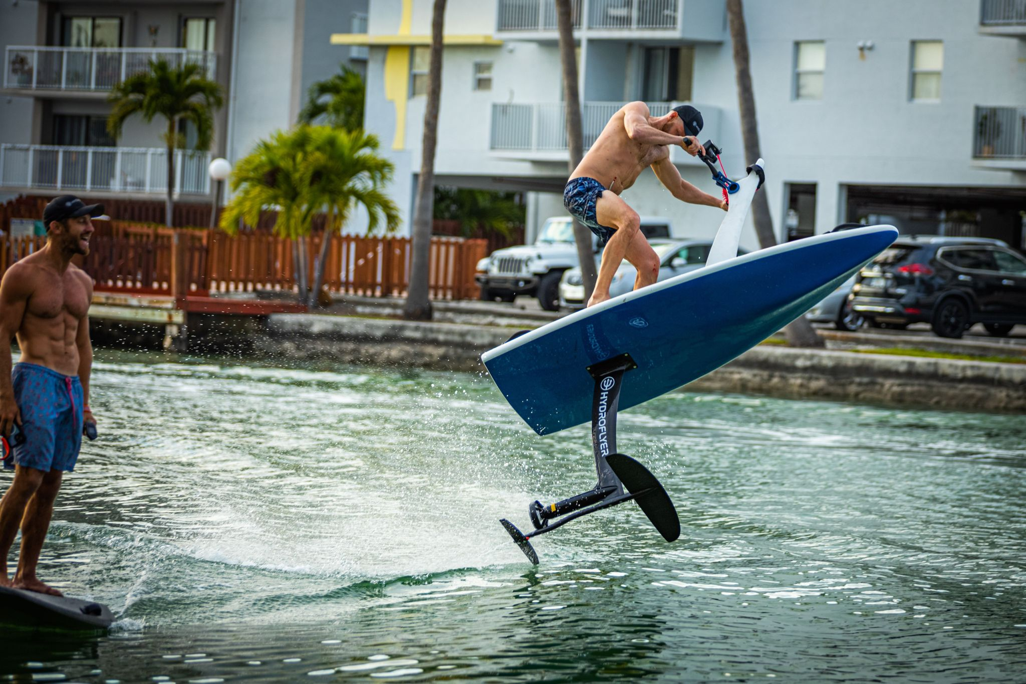 a guy on a hydrofoil making a jump